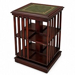 Handcrafted mahogany revolving bookcase with green leather top and gold tooling on a white background.
