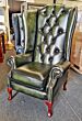 Chesterfield wing back chair in antique green leather