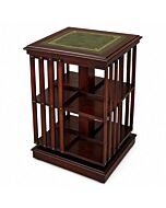 Handcrafted mahogany revolving bookcase with green leather top and gold tooling on a white background.