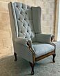 Colchester Chesterfield Wingback Chair boasts timeless elegance and features contrasting antique tan leather accents.