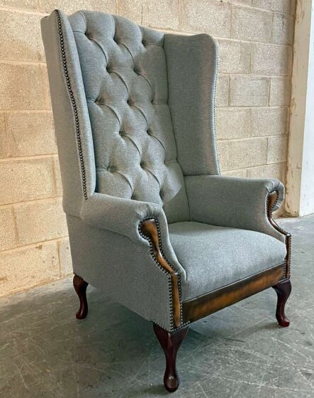 Colchester Chesterfield Wingback Chair boasts timeless elegance and features contrasting antique tan leather accents.