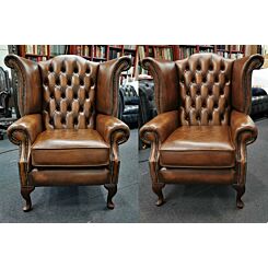 Scroll wing Chesterfield chairs in antique tan leather