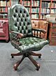 Mahogany English swivel chair in Classic green leather