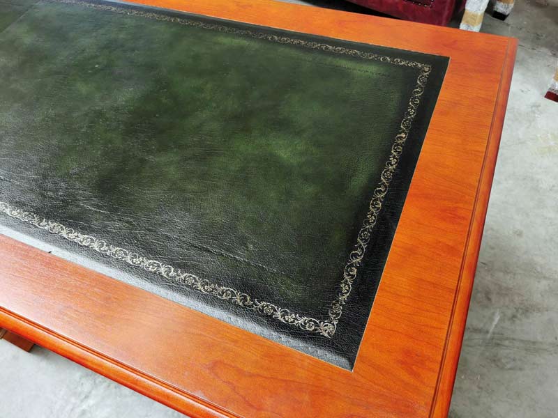 Green leather on a cherry wood desk