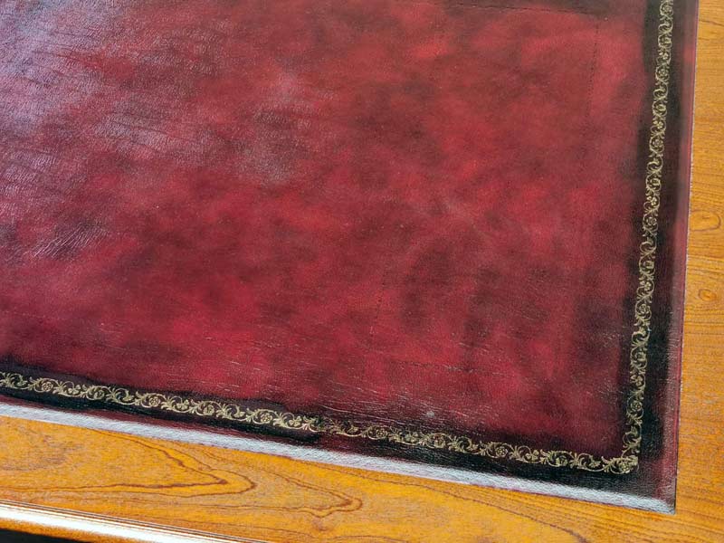 Red leather on an oak desk