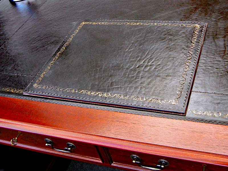 Black leather on a mhogany desk